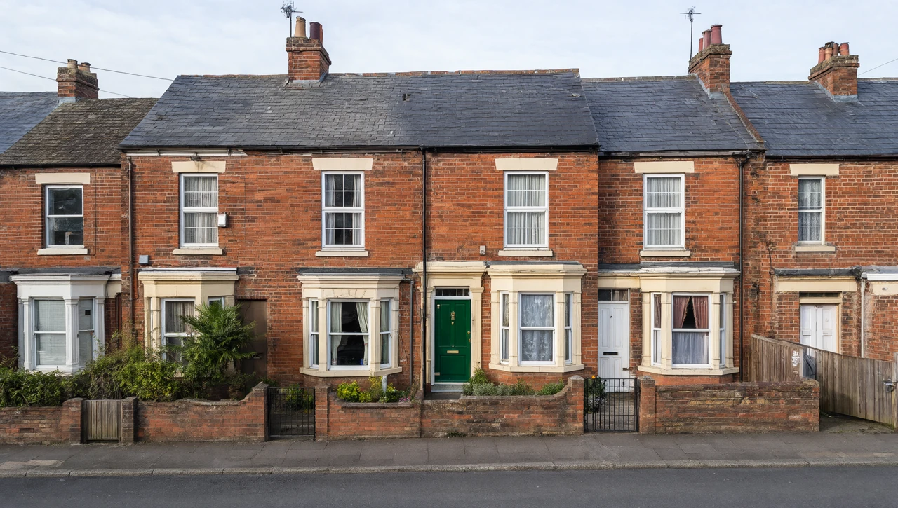 A red-brick UK terraced house